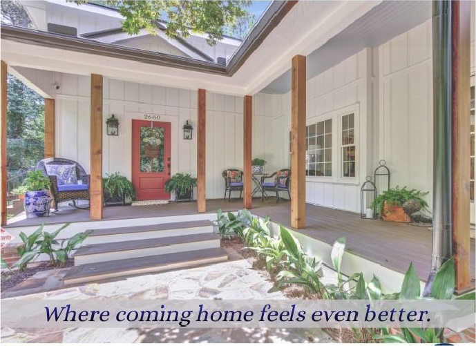 The patio entrance to a white cottage-style home